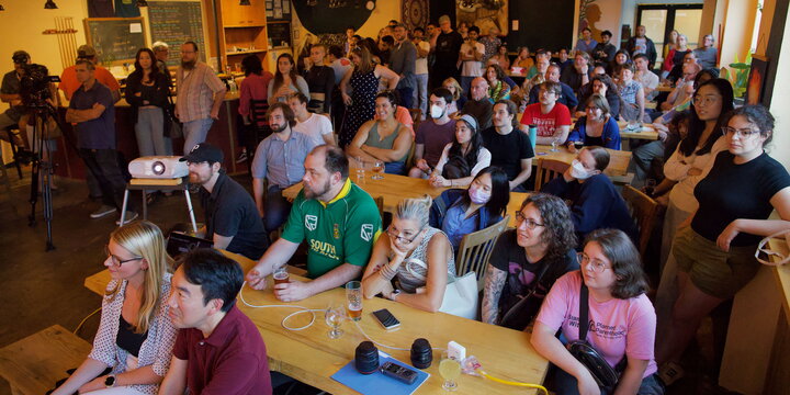A group watches an astronomy presentation.