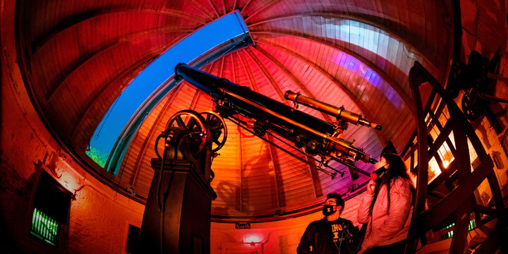 People looking through a telescope in the observatory.