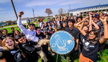 A group of people posing and cheering.
