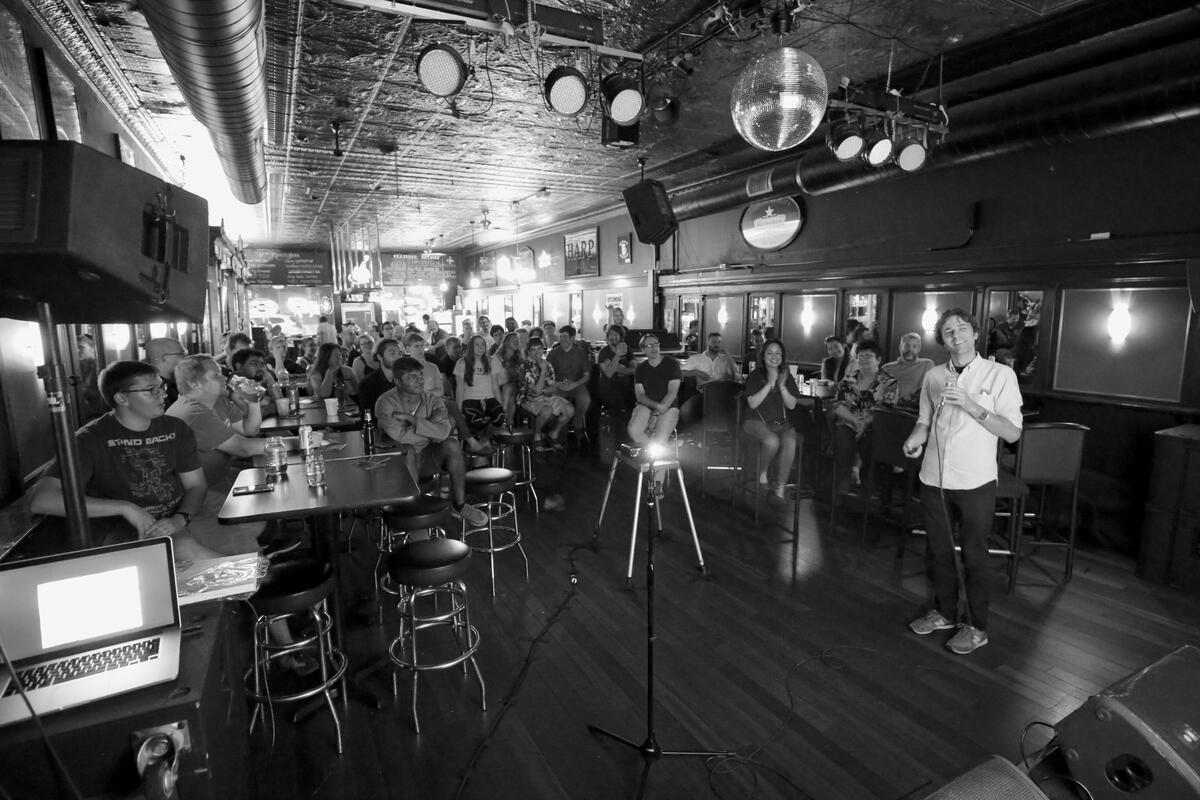 An astronomer gives a speech to a packed house.