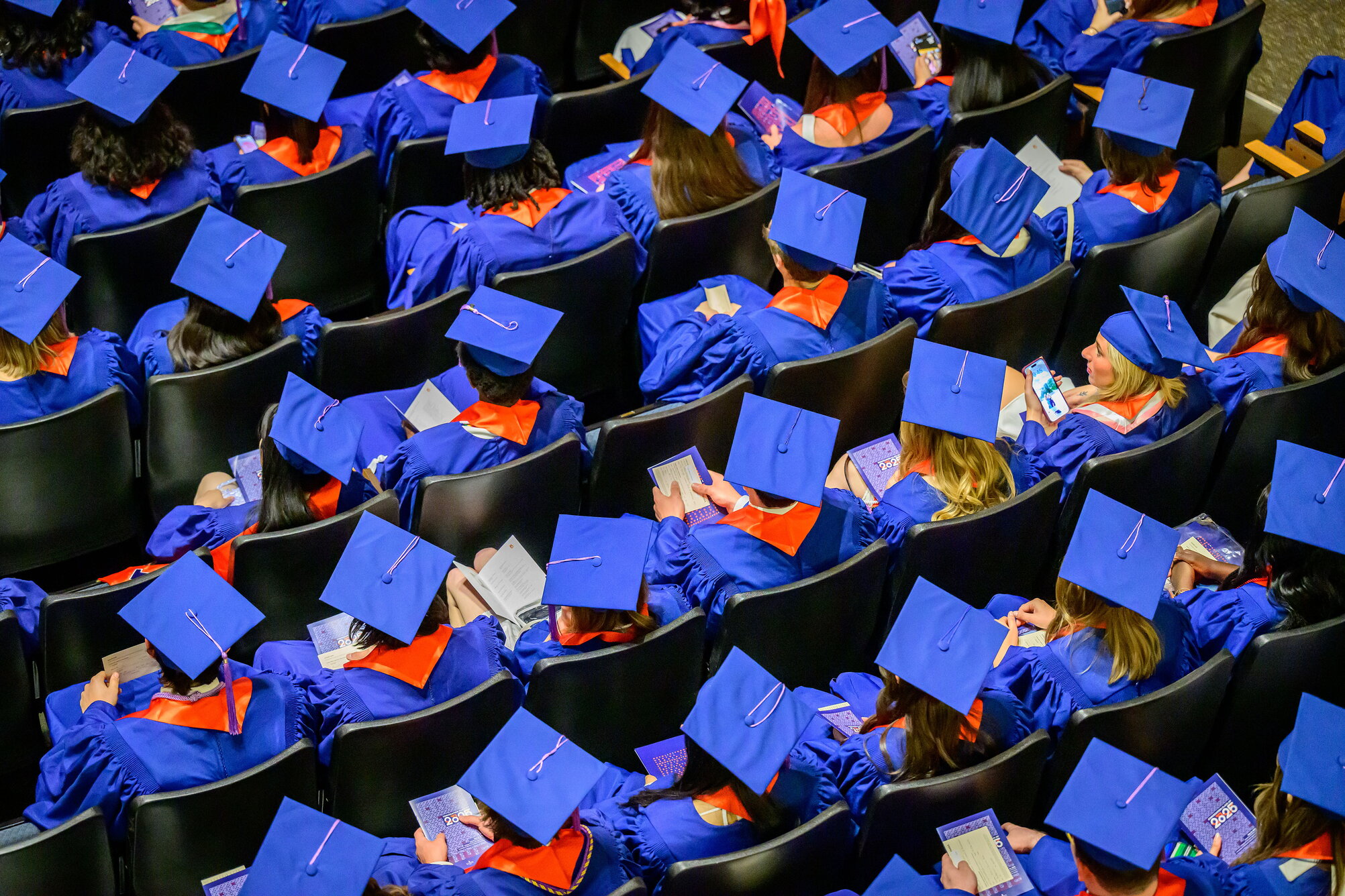 A top down view of graduates in their caps and gowns.