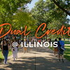 Dual Credit @ Illinois in script letters on top of students walking on the Quad.