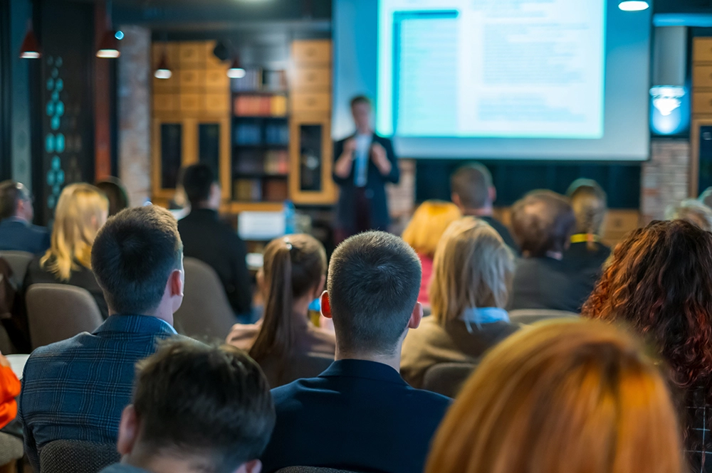 A group of people listening to a presentation.