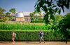 The Illinois Observatory behind the morrow plots and students walking in front of both.