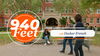 940 Feet with Decker French. Two people walking in front of brick building and people sitting on benches having a conversation.