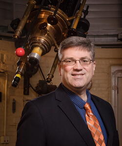 Bryan Dunne in front of the telescope at the observatory.